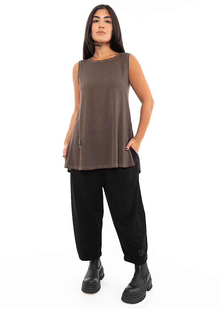 A Model wearing a Chocolate Brown fitted top with a slight A-Line flare. Styled with Black tapered trouser and a chunky Black boot.