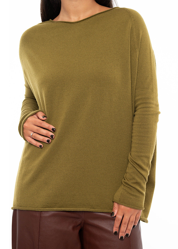 An up close off the Model wearing a relaxed fit khaki green pullover with a slash neckline and long sleeves. Showing the slight gathering around the arms.
