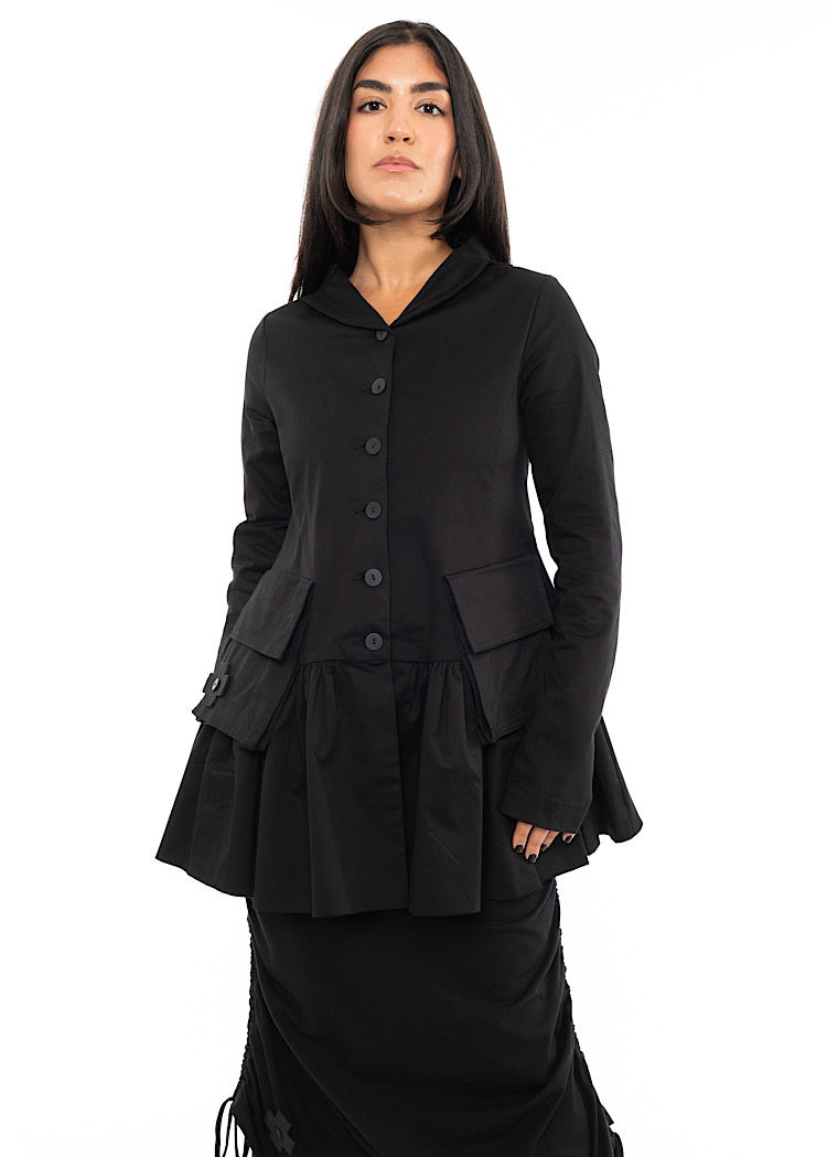 A Model wearing a Black relaxed fit Cotton Jacket, featuring long sleeves, a collared necklines and buttons to fasten.