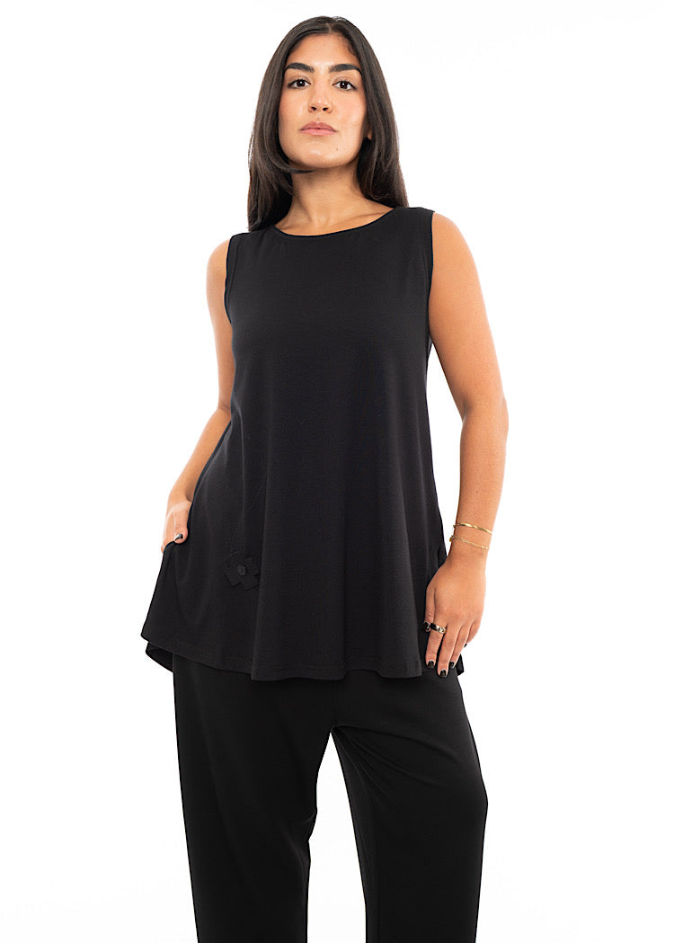 A Model wearing a fitted Black Top with slits up the side, sleeveless design and rounded neckline. Styled with Black Trouser and Chunky Black Boot.
