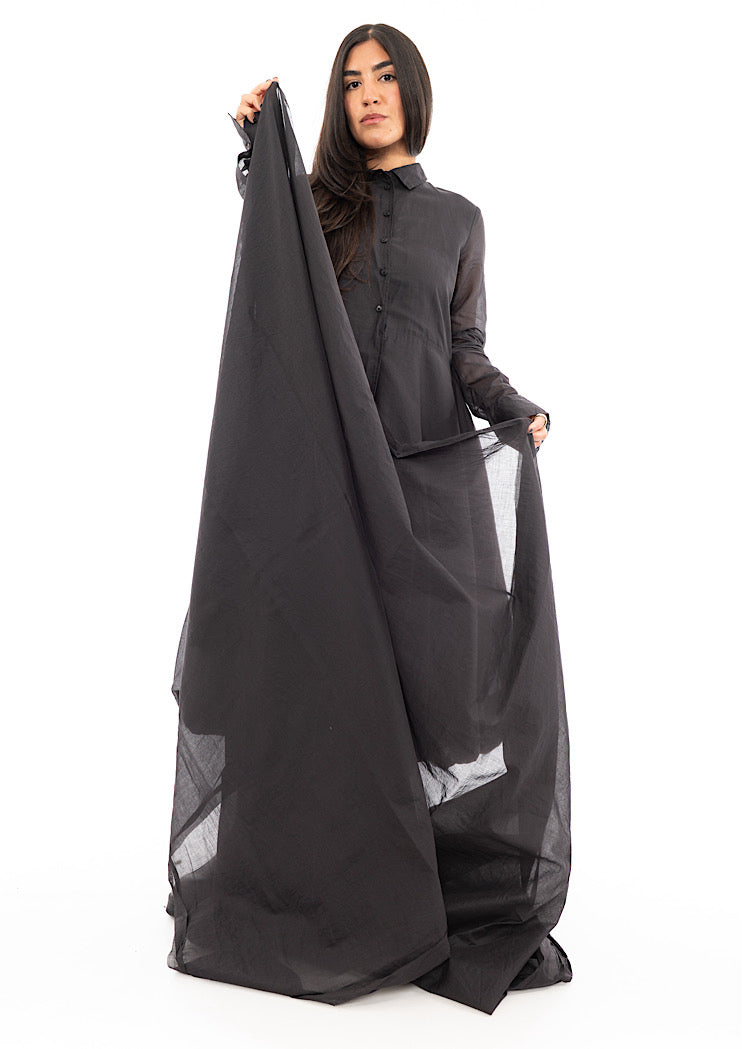 A Model holding up an oversized Grey Scarf, showing the full length and shape of Scarf.