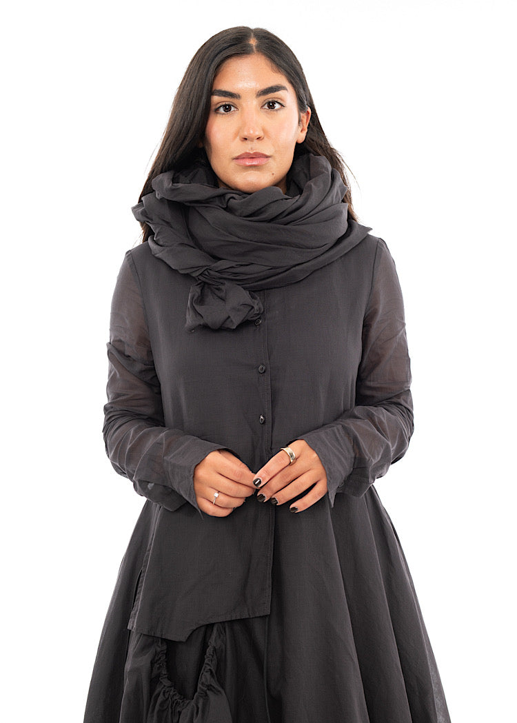 A Model wearing a washed Grey Scarf, wrapped around her neck in a design technique. Paired with a matching bubble dress.