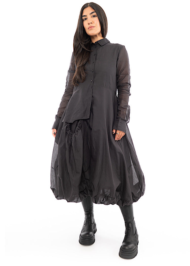 A full frame photo of A Model wearing a bubble skirted Dress in a washed Grey colour. Focusing on the size of Skirt.