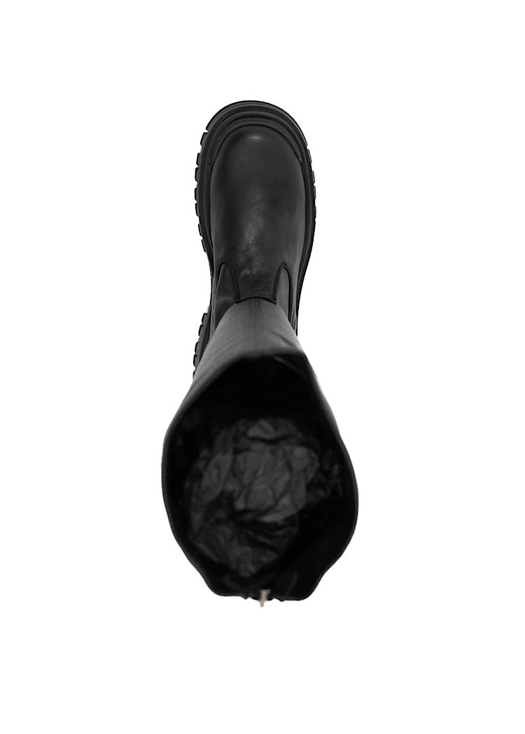 An above profile of a long chunky Black Boot with a distinct sole.Showing the inside width of the boot.