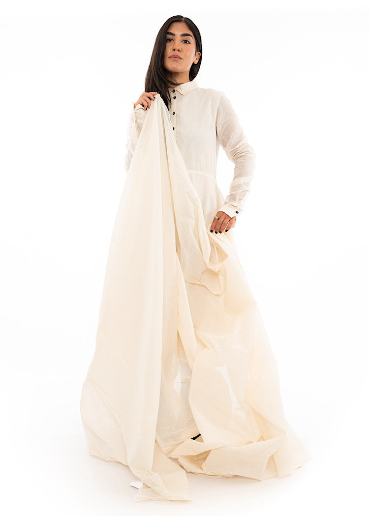 A Model holding up an oversized light beige Scarf, showing the full size and length of this.
