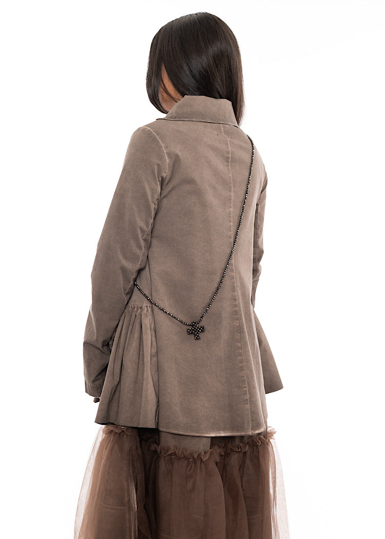 A Model standing facing the back wearing a chunky long across the body Necklace. Showing the different ways to approach Styling it.