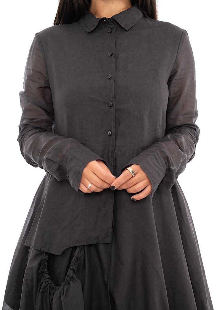 An up close off A Model wearing a bubble skirted Dress in a washed Grey colour. Focusing on the fitted blouse half of the dress.