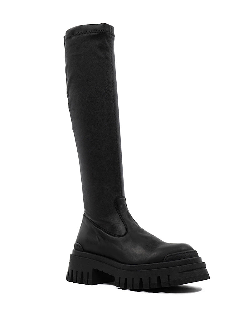 A Side profile of a long chunky Black Boot with a distinct sole.