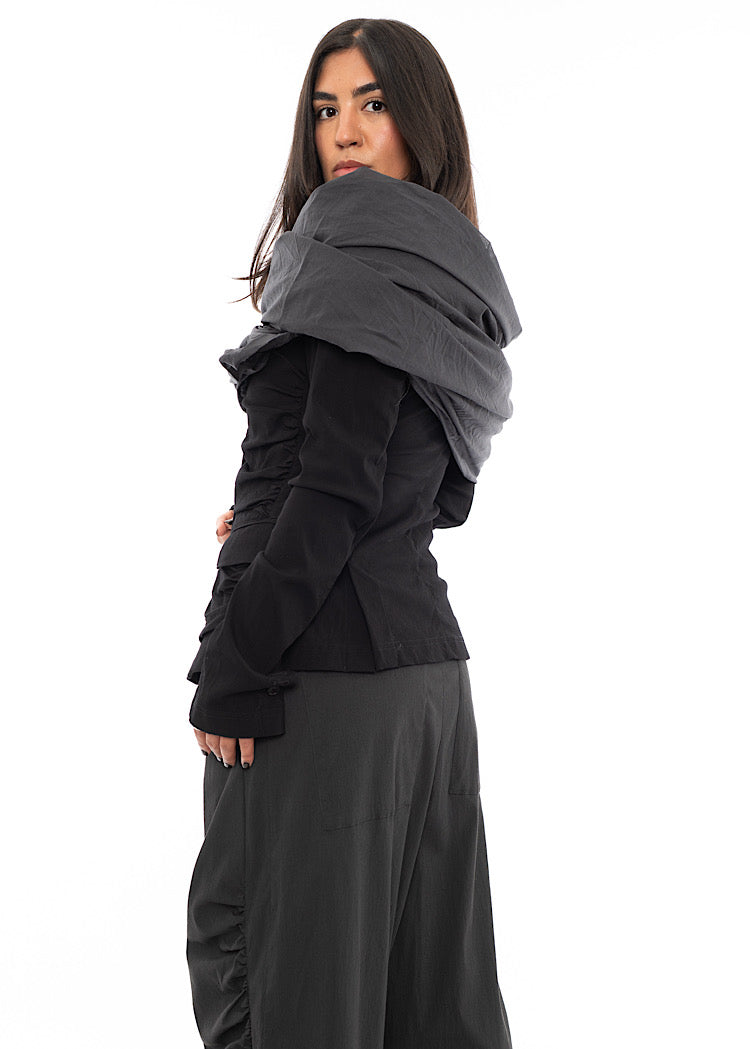 A Model wearing an oversized Scarf in a Washed Grey colour, styled with a Black Jacket and a Washed Grey trouser.