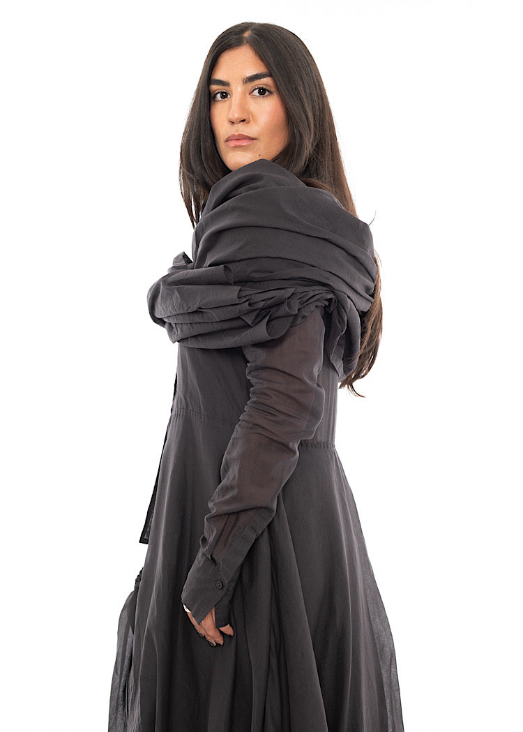 A Model wearing a washed Grey Scarf which is wrapped around her shoulders.Showing the look from the side of the outfit.