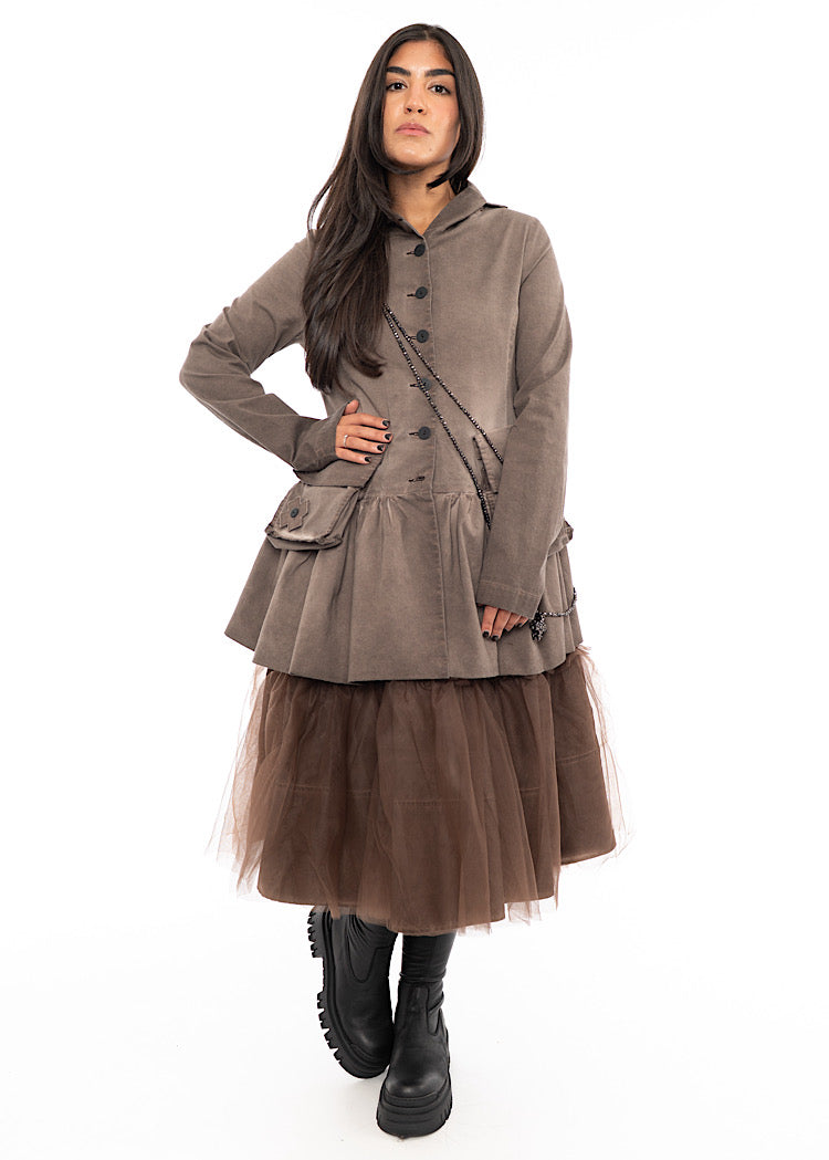 A Model wearing a Washed Brown Jacket.Styled with a matching Chocolate Brown dress, across the body necklaces and Black Boot.
