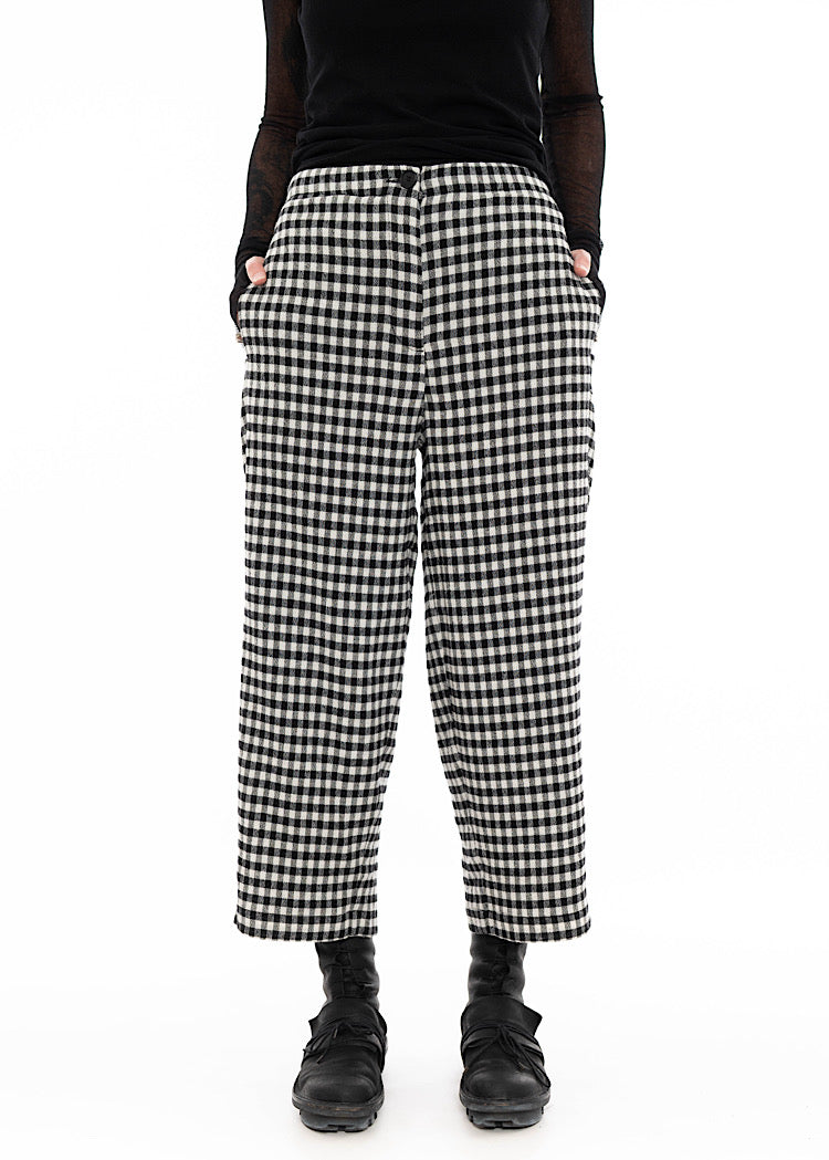 Model wearing black and white gingham check wide-leg trousers with side pockets, cropped ankle length, styled with black top and black combat boots